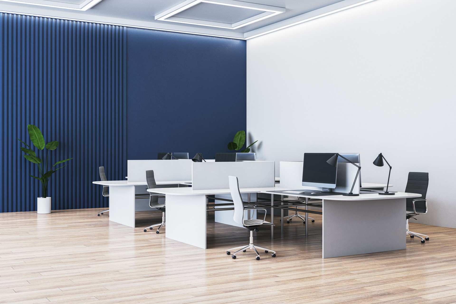 Modern, empty office with desks, chairs, and computers on a wooden floor. 3D Rendering